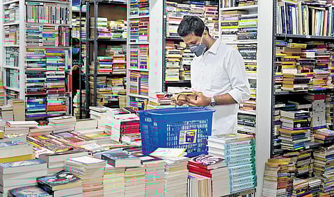 A visitor browses through the collection at the bookstore on Church Street. Express
