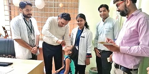 Dr Partap Chauhan of Jiva Ayurveda administering medicine on a child. (photo| EPS)