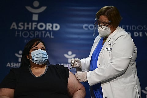 Yahaira Alicea, a respiratory therapist who treated the first two COVID-19 patients hospitalized in Puerto Rico, receives a vaccine in San Juan. (Photo|AP)