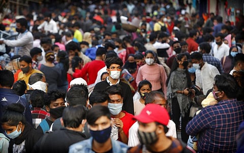 Indians wearing face masks as a precaution against the coronavirus shop at a market in New Delhi. (Photo | AP)