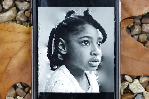 A mobile phone displaying a photograph of Ella Adoo-Kissi-Debrah who died died in February 2013 from a severe asthma attack. (File Photo | AFP)