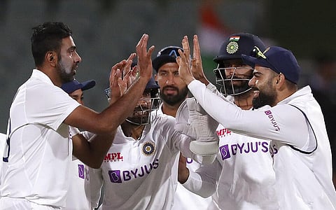 Ravichandran Ashwin celebrates with teammates after dismissing Australia's Nathan Lyon during the second day of the first cricket Test match. (Photo | AP)