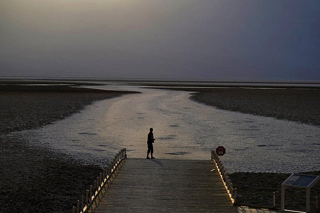 In this August 17, 2020, a person walks on a boardwalk at the salt flats at Badwater Basin, in Death Valley National Park, Calif. Death Valley recorded a scorching 130 degrees (54.4 degrees Celsius) the day before. This year has seen record Atlantic hurricanes and western wildfires, devastating floods in Asia and Africa and a hot, melting Arctic. It's not just been a disastrous year, but a year of disasters. (Photo | AP)