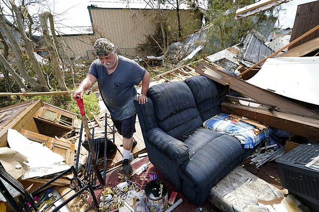In this August 29, 2020, Bradley Beard walks with a shovel through his daughter's destroyed trailer home, after searching in vain for the water shutoff valve for the property in the aftermath of Hurricane Laura, in Hackberry, La. This year has seen record Atlantic hurricanes and western wildfires, devastating floods in Asia and Africa and a hot, melting Arctic. It's not just been a disastrous year, but a year of disasters. (Photo | AP)