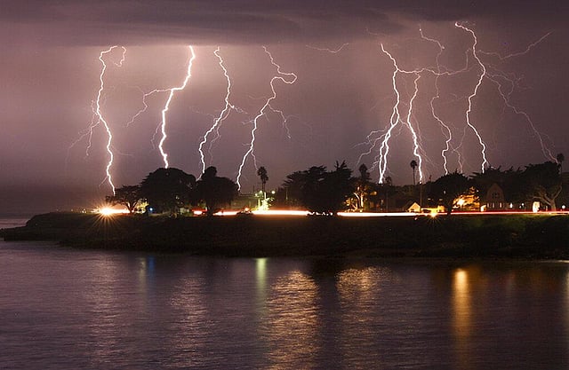 In this August 16, 2020, a rare lightning storm crackles over Mitchell's Cove in early morning in Santa Cruz, Calif. The severe storm system rolled through the San Francisco and Monterey Bay areas in August, packing a combination of dry lightning and high winds that triggered wildfires throughout the region. This year has seen record Atlantic hurricanes and western wildfires, devastating floods in Asia and Africa and a hot, melting Arctic. It's not just been a disastrous year, but a year of disasters. (Photo | AP)