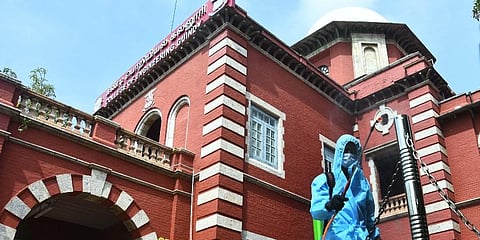 Greater chennai corporation worker sprays disinfectants around the premises of Anna University on Friday after several students were found to be COVID positive. (Photo | Ashwin Prasath, EPS)