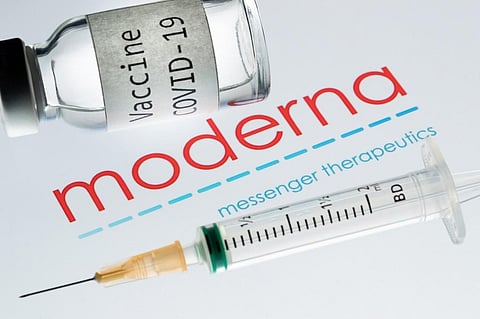 A syringe and a bottle reading 'Vaccine Covid-19' next to the Moderna biotech company logo. (File photo| AFP)