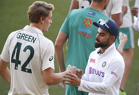 India's Virat Kohli, right, shakes hands with Australia's Cameron Green after Australia won on the third day of their cricket test match at the Adelaide Oval. (Photo | AP)