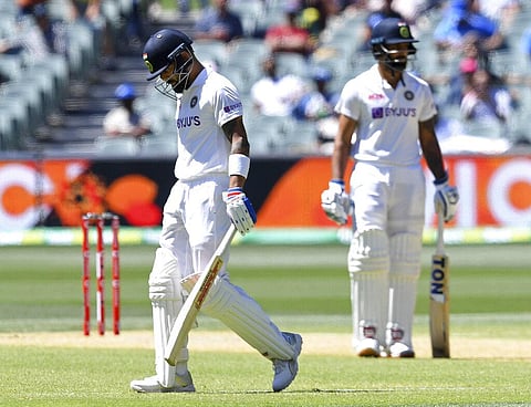India's Virat Kohli, left, begins to walk off after he was caught out for 4 runs against Australia. (Photo | AP)