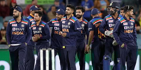 India's Virat Kohli (L) gathers with teammates following the dismissal of Australia's Aaron Finch for 75 runs during the ODI match at Manuka Oval in Canberra. (Photo | AP)