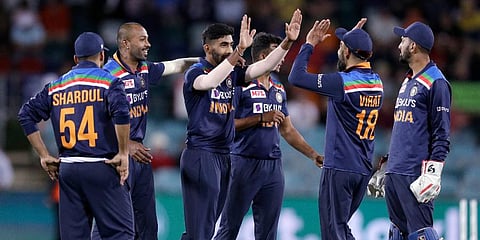 India's Jasprit Bumrah, third left, is congratulated by teammates after bowling Australia's Glenn Maxwell during the ODI match at Manuka Oval in Canberra. (Photo | AP)