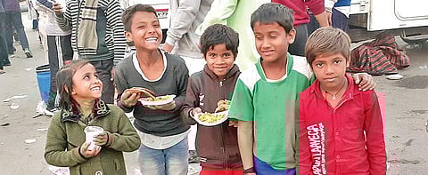 The children are all smiles after receiving food from the farmers. (Photo | EPS)