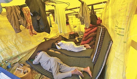 Farmers take rest at Singhu border during the ongoing ‘Delhi Chalo’ protest; Bharatiya Kisan Union members protest at Ghazipur border and protesters taking bath on Singhu border. (Photo | Shekhar/EPS)