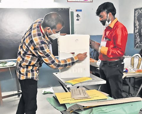 Officials seal ballot boxes after polling concluded in Hyderabad on Tuesday