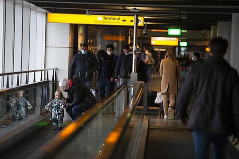 A traveller wearing a face mask checks the flight departures at Schiphol Airport, near Amsterdam, Netherlands. (Photo | AP)