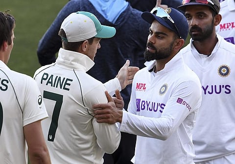 India's captain Virat Kohli (2/R) congratulates Australia's captain Tim Paine (2/L) on the third day of the first cricket Test match. (Photo | AFP)