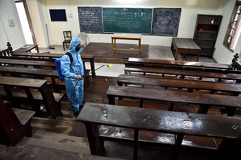 Health department workers disinfect premises and classromms of government arts college. (Photo | A Raja Chidambaram, EPS)
