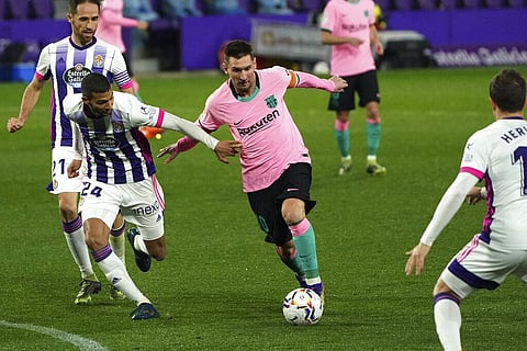 Valladolid's Joaquin Fernandez, left, tries to hold off Barcelona's Lionel Messi during a Spanish La Liga soccer match between Valladolid and Barcelona. (Photo | AP)