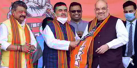 Newly inducted BJP leader Suvendu Adhikari with Amit Shah during the latter's rally in Kolkata on Sunday. (Photo | PTI)