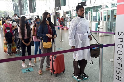 Passengers at Kempegowda International Airport on Wednesday with all safety measures in place. (Photo | Nagaraja Gadekal/EPS)