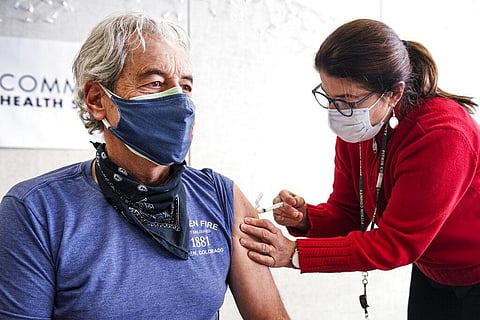 Aspen Fire Chief Rick Balentine receives a Moderna COVID-19 vaccine from family planning nurse Linda Vieira at the Community Health Services building in Aspen, Colo. (Photo | AP)