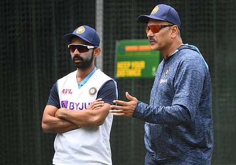 India's captain Ajinkya Rahane (L) and coach Ravi Shastri (R) chat as the team trains ahead of the second cricket Test match against Australia. (Photo | AFP)