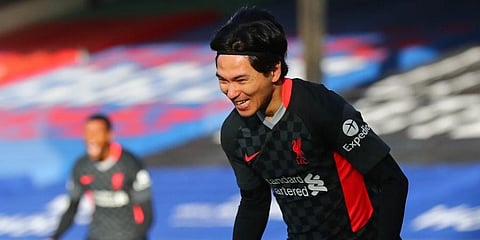 Liverpool's Japanese midfielder Takumi Minamino celebrates scoring the opening goal during the English Premier League football match against Crystal Palace. (Photo | AFP)