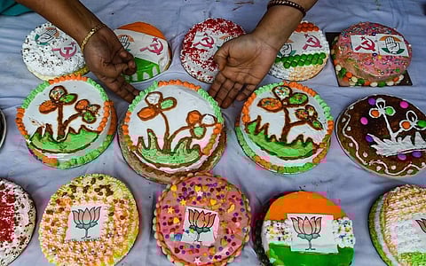 A woman sells cakes decorated with political party symbols for the upcoming Christmas festival in Kolkata Wednesday Dec. 23 2020. (Photo | PTI)