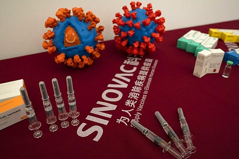 Syringes of a vaccine for COVID-19 and models depicting the coronavirus are displayed at the Sinovac factory in Beijing on Thursday, Sept. 24 (Photo | AP)