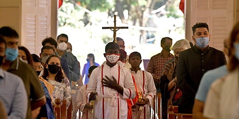 Christmas during the pandemic sees devotees in Masks and maintaining Social Distancing in St. Patrick's Church. (Photo | EPS/Maghana Sastry)