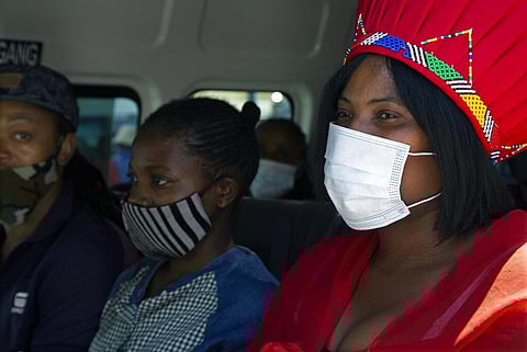 People wear face masks to protect against coronavirus, aboard a minibus taxi, in Johannesburg's main railway station. (Photo | AP)