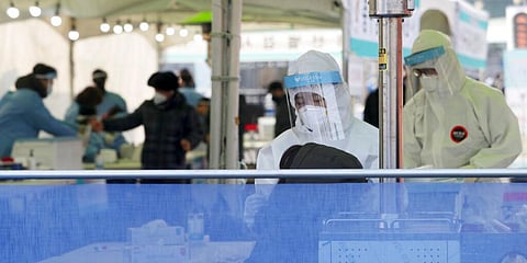 A medical worker wearing protective gear takes sample during a COVID-19 testing at coronavirus testing site. (Photo | AP)
