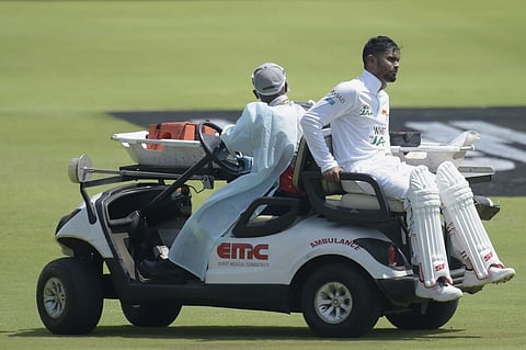 Sri Lanka's Dhananjaya de Silva (R) is helped off the field by medical staff after being injured during the first day of the first Test cricket match. (Photo | AFP)