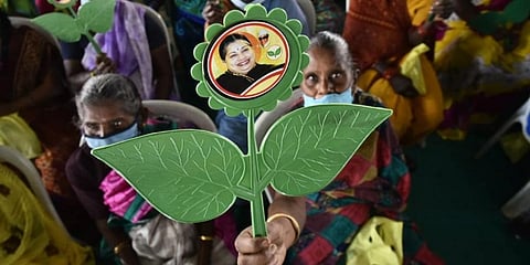 Onlookers with late chief minister J Jayalalithaa's banner at AIADMK's campaign for Assembly elections at YMCA Grounds, Royapettah. (Photo | P Jawahar, EPS)