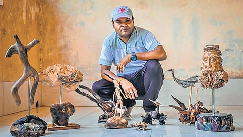Satya Ketan Mohanty with his collection of wood sculptures