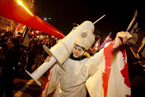 An Israeli protester is seen during a demonstration against Israeli Prime Minister Benjamin Netanyahu in Jerusalem, Saturday, Dec. 26, 2020. (Photo | AP)
