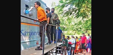 People give their swab samples for Covid-19 test at Sanjeevini bus at the ENT Hospital in Visakhapatnam on Saturday | G Satyanarayana