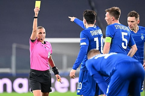 French referee Stephanie Frappart gives a yellow card to Dynamo Kiev's Ukrainian midfielder Nicholas Shaparenko (C). (Photo | AFP)
