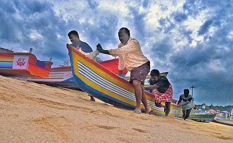 Fishermen take their boats to safety following the cyclone warning in Thiruvananthapuram on Wednesday. | Vincent Pulickal