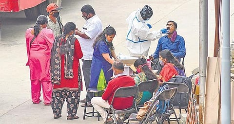 Medical workers collect swabs from citizens at a Covid-19 booth at Majestic Bus Stand in Bengaluru on Wednesday | ASHISHKRISHNA HP