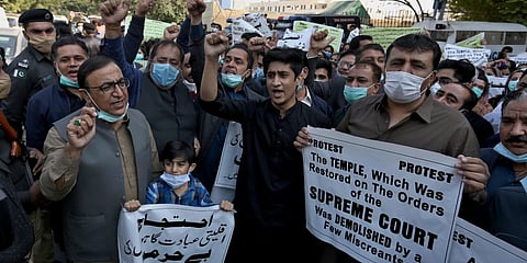 Pakistan Hindu Council members hold a protest against the attack on a Hindu temple in the northwestern town of Karak. (Photo| AP)