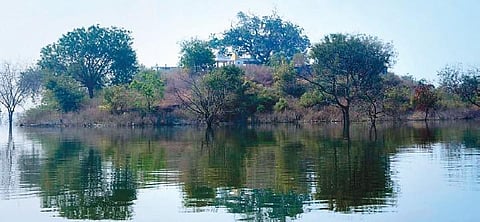The now-submerged village of Vardavelli in Boinpally mandal, Karimnagar district, in the middle of backwaters of the Mid Manair Dam; (below) pilgrims ferry on a boat to reach the Sri Guru Dattatreya S