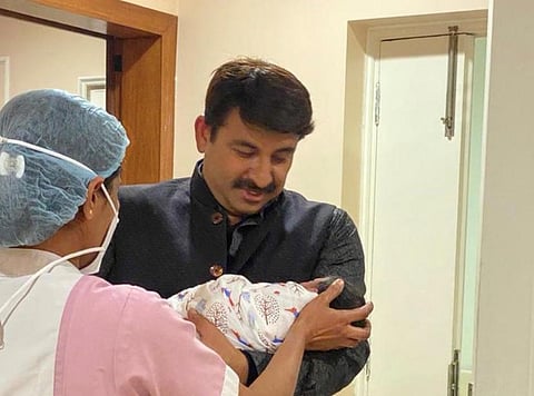 BJP MP Manoj Tiwari holding his newborn daughter (Photo | Manoj Tiwari, Twitter)