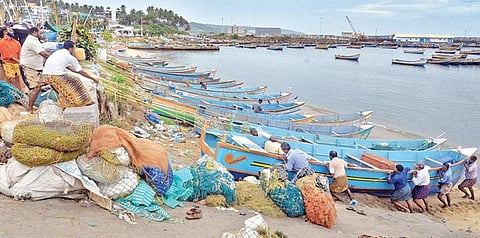 Fishermen pull their boats ashore at Vizhinjam in Thiruvananthapuram after an alert was sounded in the district owing to Cyclone Burevi | Vincent Pulickal