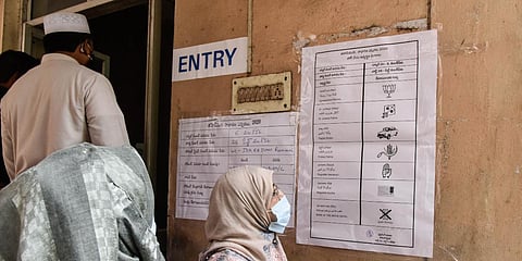 Voters cross checking the symbols before entering in to the polling station during the repolling of Old Malakpet division. (Photo | EPS/Vinay Madapu)