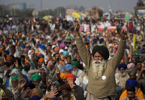 An elderly farmer shouts slogans as others listen to a speaker as they block a major highway during a protest to abolish new farming laws. (Photo | AP)