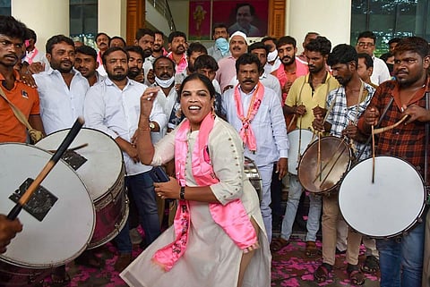 Telangana Rashtra Samithi workers celebrate their party's lead in the Greater Hyderabad Municipal Corporation (GHMC) election in Hyderabad. (Photo | PTI)