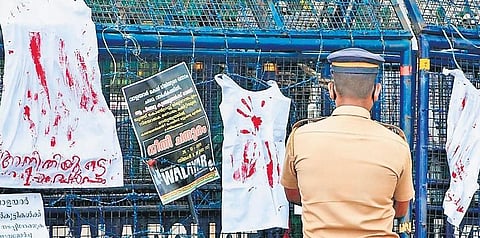 Petticoats hung on a barricade near the Secretariat seeking justice for the two minor girls who were raped and murdered in Walayar. A policeman looks on | File pic