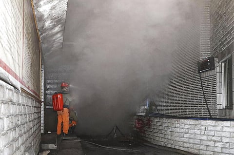 Rescue workers gauge the density of carbon monoxide in the smog at the entrance of the coal mine in Yongchuan District of Chongqing. (Photo | AP)
