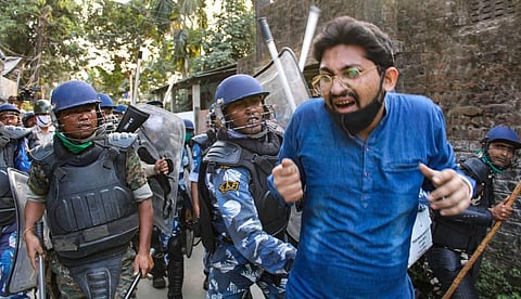 Police clash with BJP workers during their Uttarkanya Abhiyaan to protest against alleged corruption and deteriorating law and order in the state in Siliguri Monday Dec. 7 2020. (Photo | PTI)
